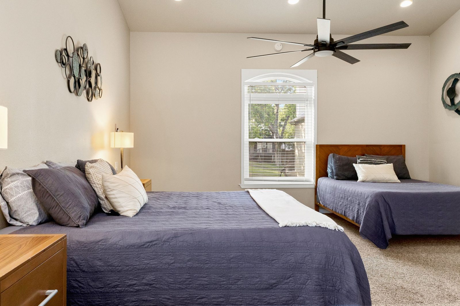 Master bedroom with king bed and warm wood ceiling