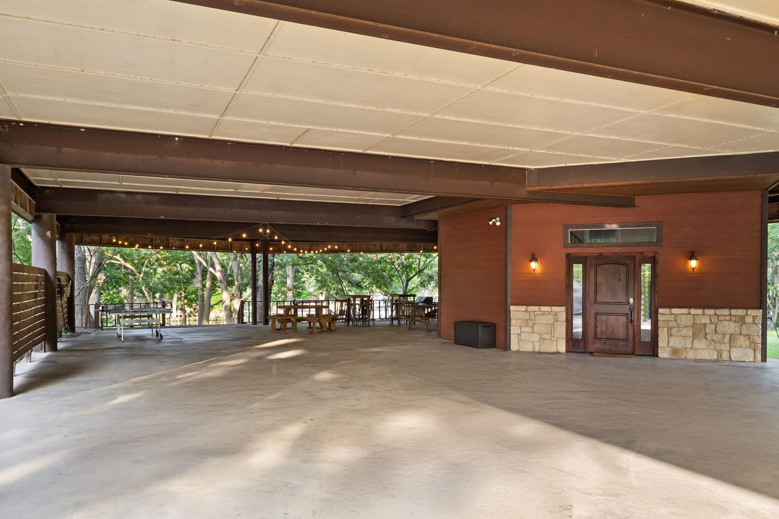 Large covered gathering area beneath the raised house